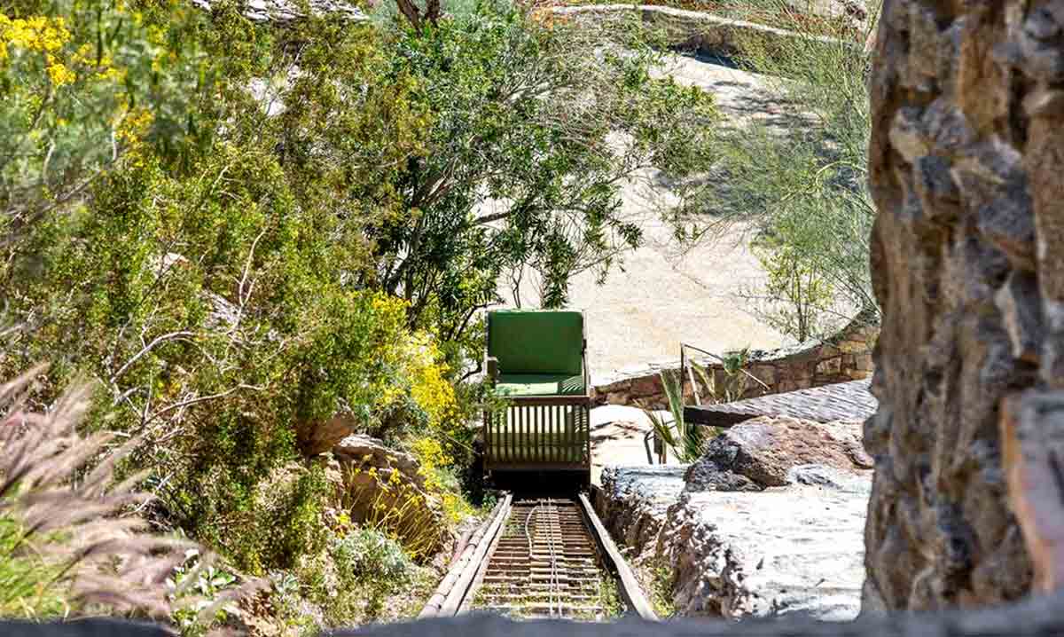 An outdoor carriage, in the form of a custom funicular, transports passengers up to the residence